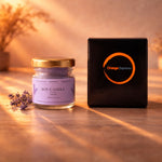 An Orange Espresso Handmade paraffin free soy candle in lavender aroma next to its premium black packaging.