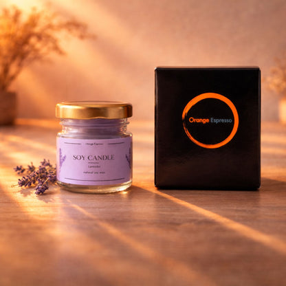 An Orange Espresso Handmade paraffin free soy candle in lavender aroma next to its premium black packaging.