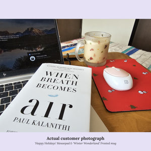 Book and laptop with Orange Espresso red mousepad and Orange Espresso frosted mug filled with a beverage.