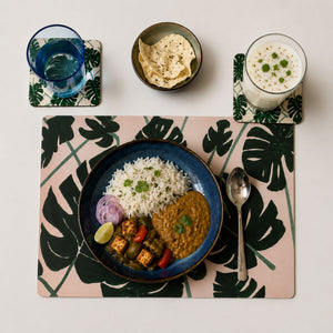 An Indian meal on the Monstera Leaves designed placemat with water and buttermilk glasses on the Monstera leaves designed coasters.
