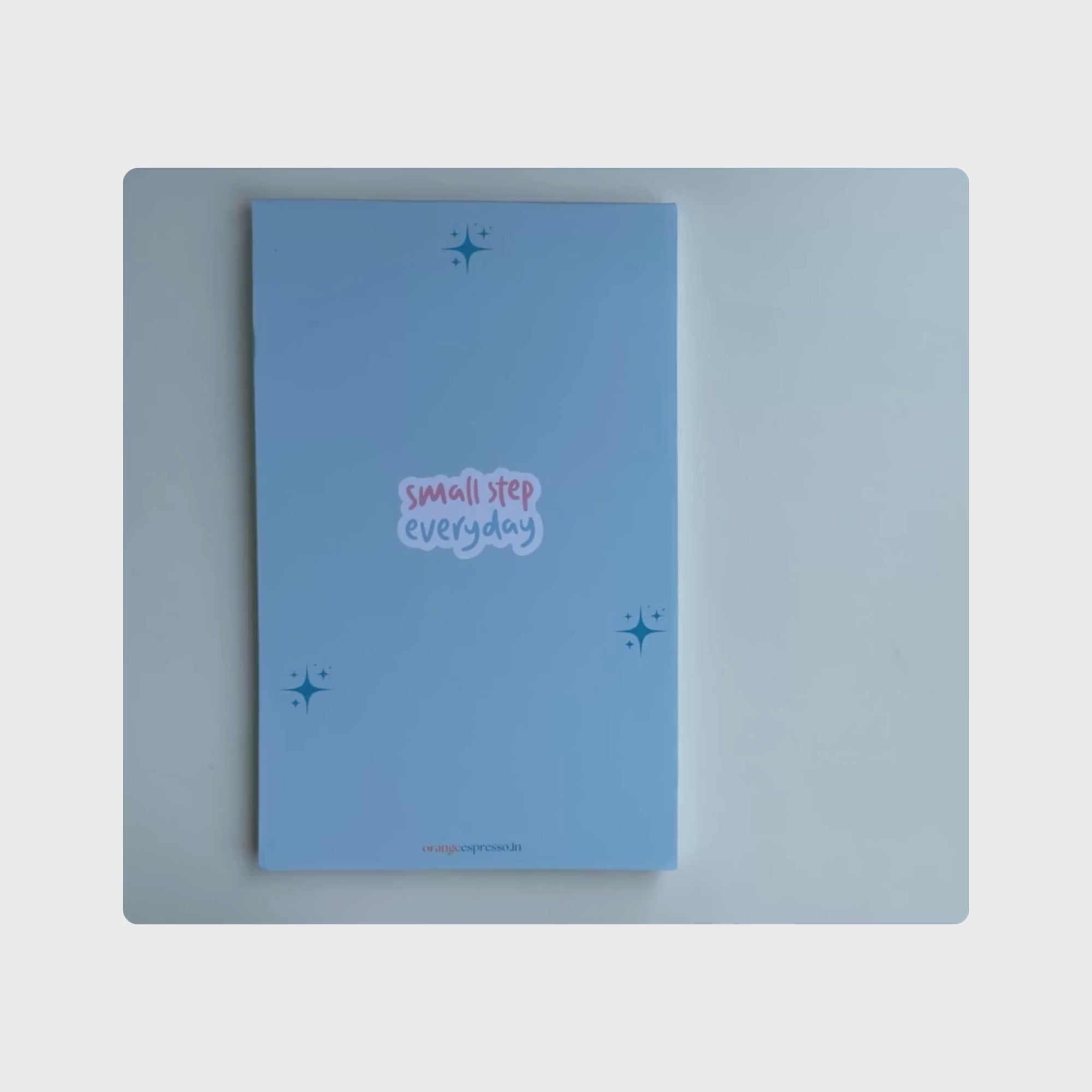 product overview of the small step everyday task organizer. The cover is blue in colour with light blue inner pages.